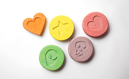 Ecstasy tablets on white background